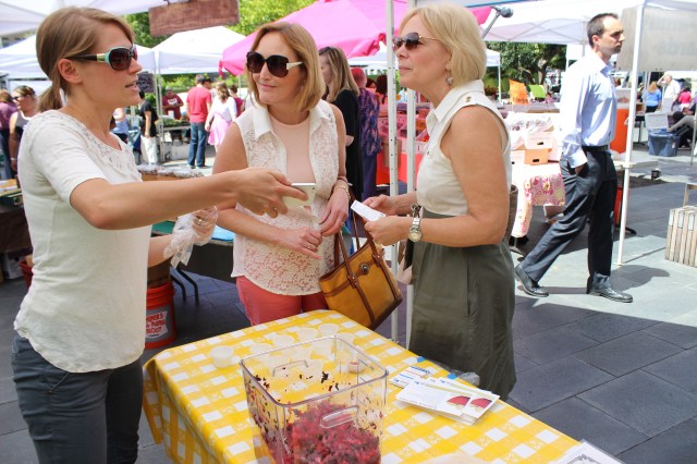 Lindsey Hoeft shows a picture to explain what a kohlrabi is to Express Market goers.