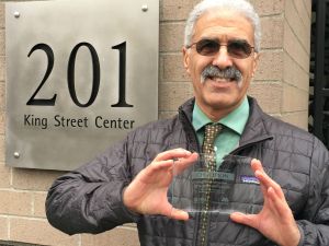 Employee Transportation Program Manager Hossein Barahimi holds one of seven awards received by King County from the City of Seattle Commute Trip Reduction Program.