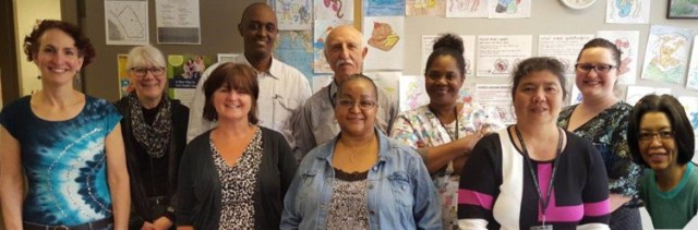 The staff at Public Health’s Refugee Health clinic from L-R, back Debra Vonnahme, Franck Bamage, Hossein Eslami, Helena Wilson-Brown, JenRenee Paulson; front Wendy Dell, Annette Holland, Shary Robinson, Maggie Po, Vilay Wang
