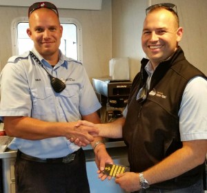 Pictured: Nick Williams, on the left, receiving Captains epaulets from Deckhand/Relief Captain GW Rogers.