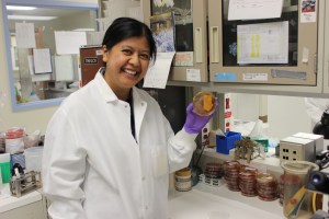 Senior Microbiologist Kristine Mejilla holding a petri dish being tested.