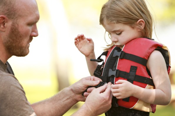 dad-putting-life-jacket-on-girl